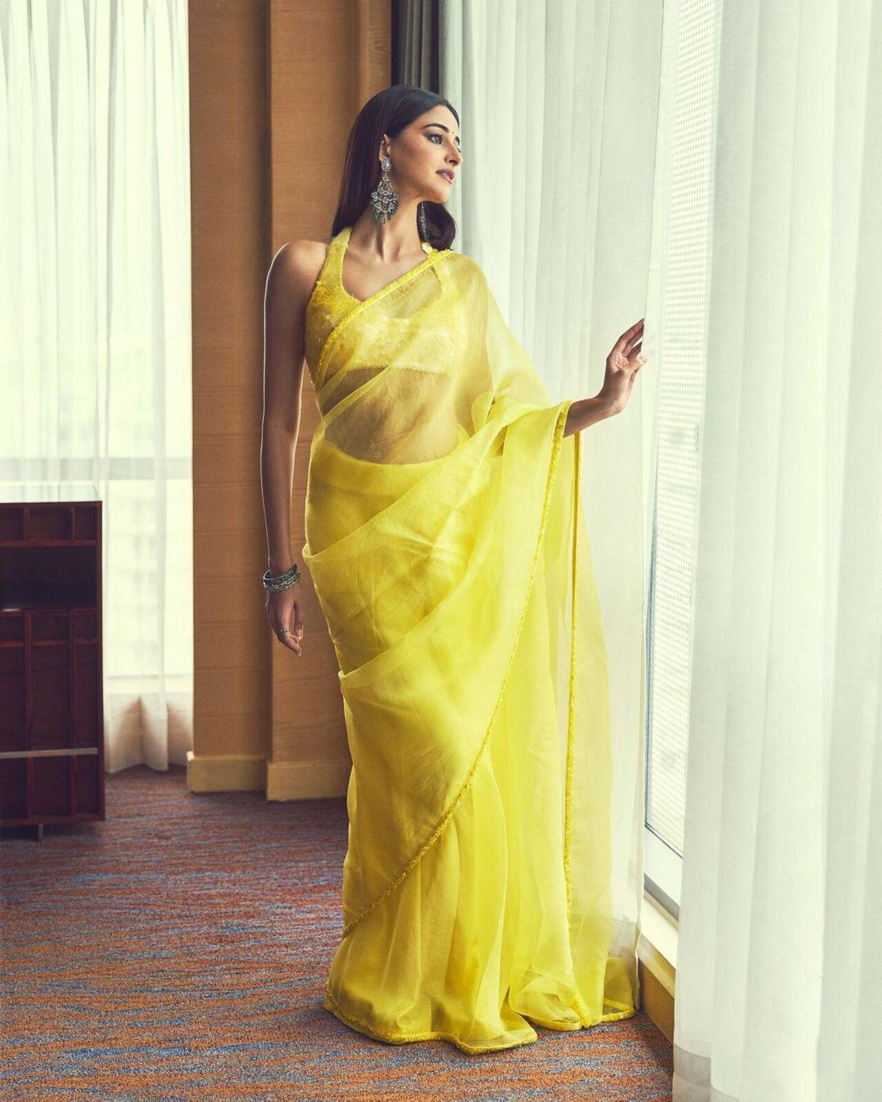 Ananya Panday wore a yellow Manish Malhotra saree for one of the promotional rounds. The saree came with a sequinned border and blouse